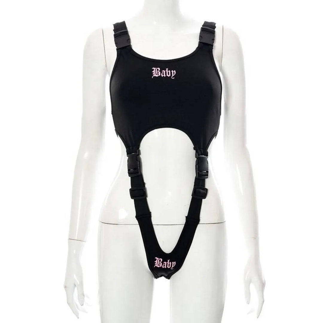 Black Baby cut-out bodysuit with buckle straps and attached garter-style suspenders, pink Baby text.