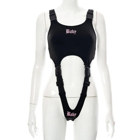 Black Baby cut-out bodysuit with buckle straps and attached garter-style suspenders, pink Baby text.