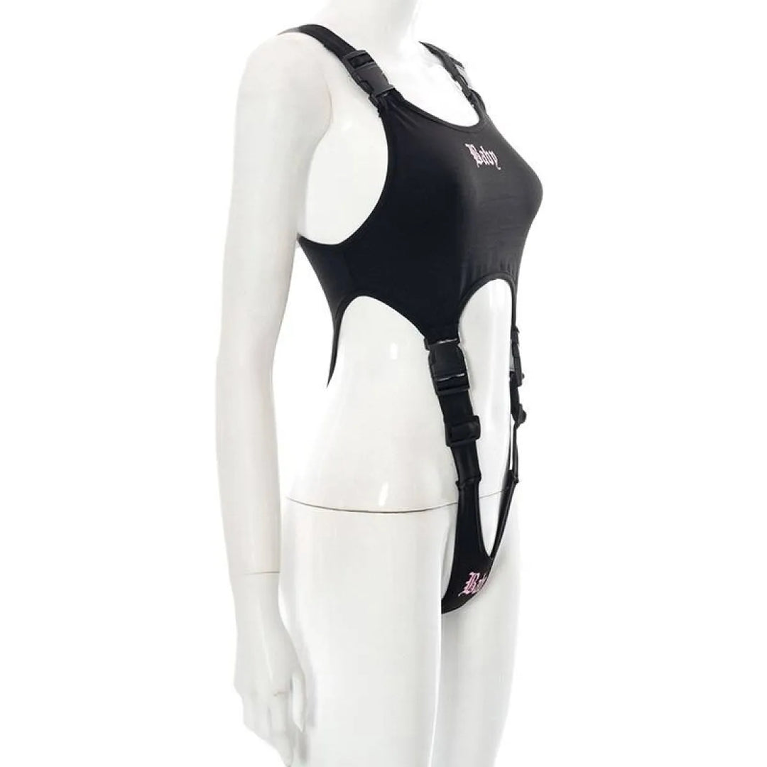 Black Baby cut-out bodysuit with harness straps and buckles on a mannequin.